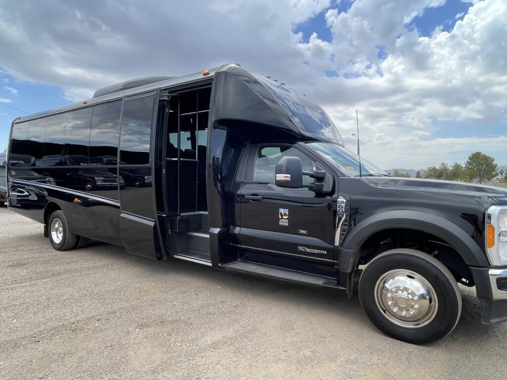 A black shuttle bus with tinted windows displays